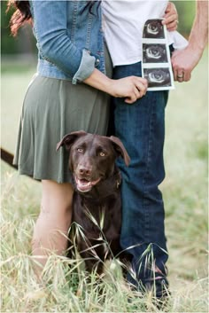 a man and woman standing next to each other with a dog in front of them