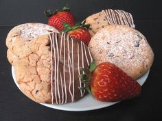 some cookies and strawberries on a white plate