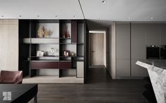 a living room filled with furniture next to a wall mounted book shelf and a marble counter top