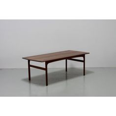 a wooden table sitting on top of a white floor