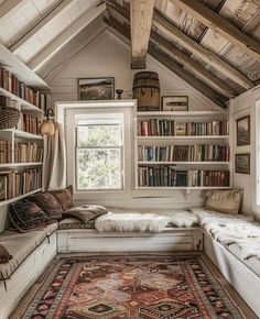 a room filled with lots of books on top of a book shelf next to a window