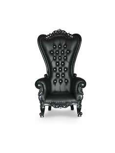 a black leather chair with ornate carvings on the back and arms, sitting in front of a white background