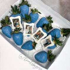 a box filled with blue chocolate covered strawberries