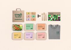 the contents of a lunch box laid out on a white surface with paper, scissors and other items