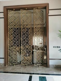 an ornately designed room divider in the middle of a marble flooring area