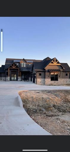 a large house sitting on top of a dirt field