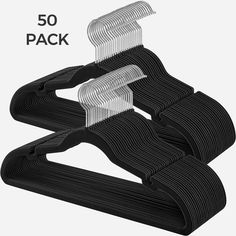 three pieces of black plastic hangers with white clips on each side and one piece in the