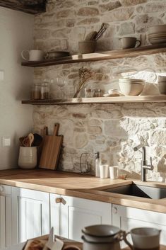 the kitchen counter is clean and ready to be used for cooking or baking, as well as dishes on shelves