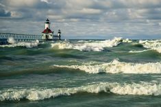 waves crashing in front of a light house