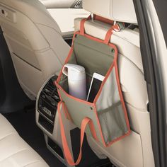 the interior of a car with cup holders and cups in its back seat pocket,