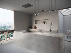 a modern kitchen with an island counter and stools