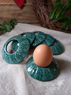 an egg sitting on top of some green plates