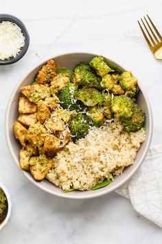 a bowl filled with rice, broccoli and chicken