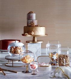 a table topped with lots of different types of cakes and desserts on top of it