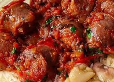 meatballs and pasta with tomato sauce on a plate