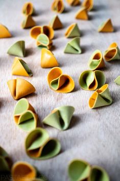 some green and yellow pieces of paper on a table