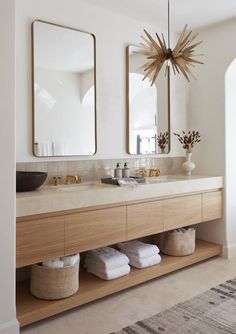 a bathroom with two sinks and large mirrors