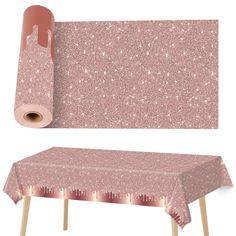 a pink table cloth with glitter on it next to a roll of paper and wooden legs