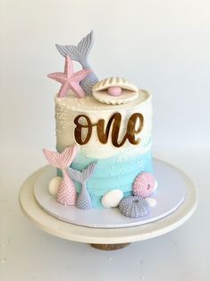 a one year old birthday cake with mermaid decorations