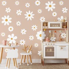 a child's playroom with pink and white flowers on the wall