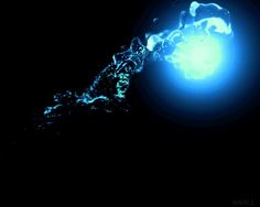 a blue light shining in the dark with water splashing on it's side