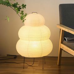 a lamp sitting on top of a wooden floor next to a chair