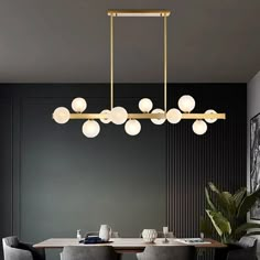 a dining room table with chairs and a chandelier hanging from it's ceiling