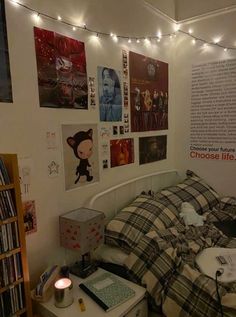 a bedroom with posters on the wall and a bed covered in checkered comforter