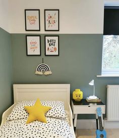 a bed room with a neatly made bed and a toy guitar on the floor next to it