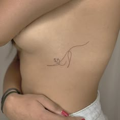 a woman's stomach with a small tattoo on it