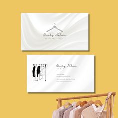 two business cards with clothes on hangers