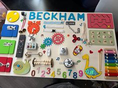 a child's play table with toys and magnets on it that says beckham