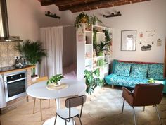 a living room filled with furniture next to a stove top oven and refrigerator freezer