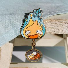 a close up of a key chain with a cartoon character hanging from it's side