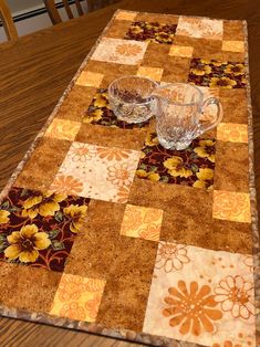 the table is set with two glass dishes and one bowl on top of the placemat