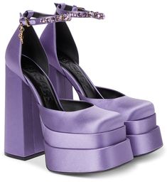 The Medusa Aevitas pumps from Versace are a lesson in statement glamour. They're made from purple satin with towering double platform soles and slender ankle straps that are embellished with crystals and Medusa charms. | Versace Medusa Aevitas satin platform pumps Versace Medusa Platform Pumps, Luxury Sandals With Red Sole For Spring, Mach Mach Shoes Purple, Cassie Euphoria Shoes, Purple Chunky Platform Heels, Versace Medusa Platform Heels White, Versace Heels, Basic Shoes, Dr Shoes