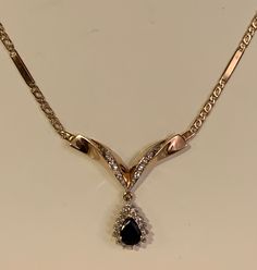 Vintage 14k gold collier necklace, with diamonds and centre blue sapphire. This necklace is a combination of a hand picked chain and pendant, skilfully combined by a leading Amsterdam jeweller, which makes to be the only one in the world! Fully hallmarked for 14k gold, with the makers mark. The centre natural sapphire stone measures 7.5mm/6mm. Apr. 1.5ct., surrounded by 15 natural diamonds. Additional 8 natural diamonds on the wings of the pendant. In total apr. 0.5ct. of diamonds. Length of the Black Dress Diamond And Sapphire Jewelry, Black Sapphire Necklace, Formal Sapphire Teardrop Pendant Necklace, Gold Sapphire Necklace For Formal Occasions, Elegant Yellow Gold Sapphire Diamond Necklace, Formal Gold Sapphire Necklace, Gold Sapphire Necklaces With Diamond Accents, Vintage Diamond Necklace, 14k Gold Bangle Bracelet