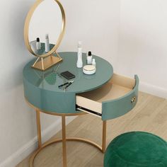 a round table with a mirror and various items on it in front of a white wall