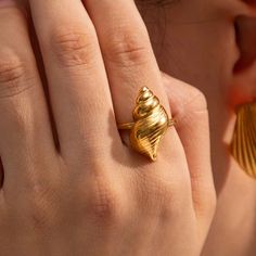 Bring a piece of the ocean with you everywhere with our Conch Shell Open Ring. Embrace eternal summer vibes and vacation memories with this unique accessory. Metal: 18K Gold over Stainless Steel Size: Adjustable/ as is fits size 7 Gold Ocean-inspired Rings For Beach, Summer Beach Jewelry Ring, Beach Summer Jewelry Ring, Summer Beach Ring Jewelry, Ocean-inspired Shell Rings For Beach, Gold Open Ring For Summer, Summer Shell Jewelry For Gifts, Ocean-inspired Yellow Gold Beach Jewelry, Gold Shell Rings For Beach