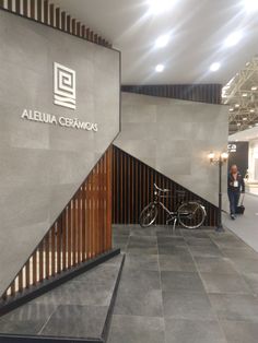 a bike is parked in front of the entrance to a building with stairs and wooden slats