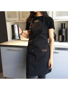 a woman standing in front of a coffee maker