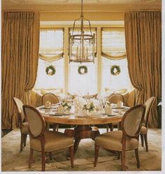 a dinning room table with chairs and a chandelier hanging from the ceiling