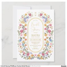 an elegant floral wedding card with gold foil and watercolor flowers on the front, in white