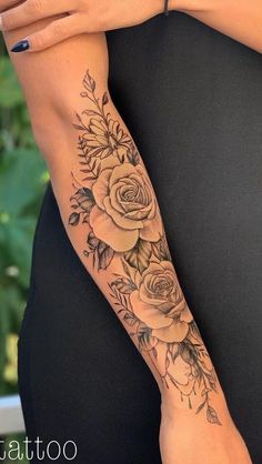 a woman's arm with flowers on it