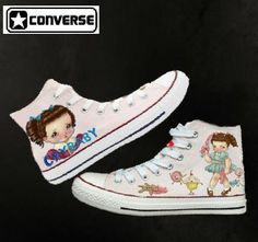 a pair of white shoes with cartoon characters on them