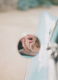 the reflection of a woman's hand in a mirror