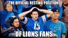 a man in a blue shirt is holding his hands up to his head with the words lions fans behind him