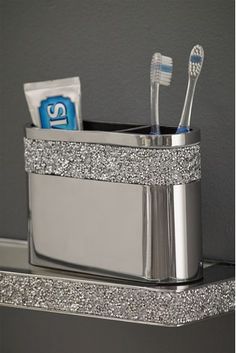 the toothbrush holder has two toothpastes in it and is silver with sparkles