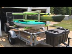 two kayaks are attached to a trailer