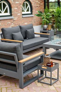 a couch and table on a brick patio